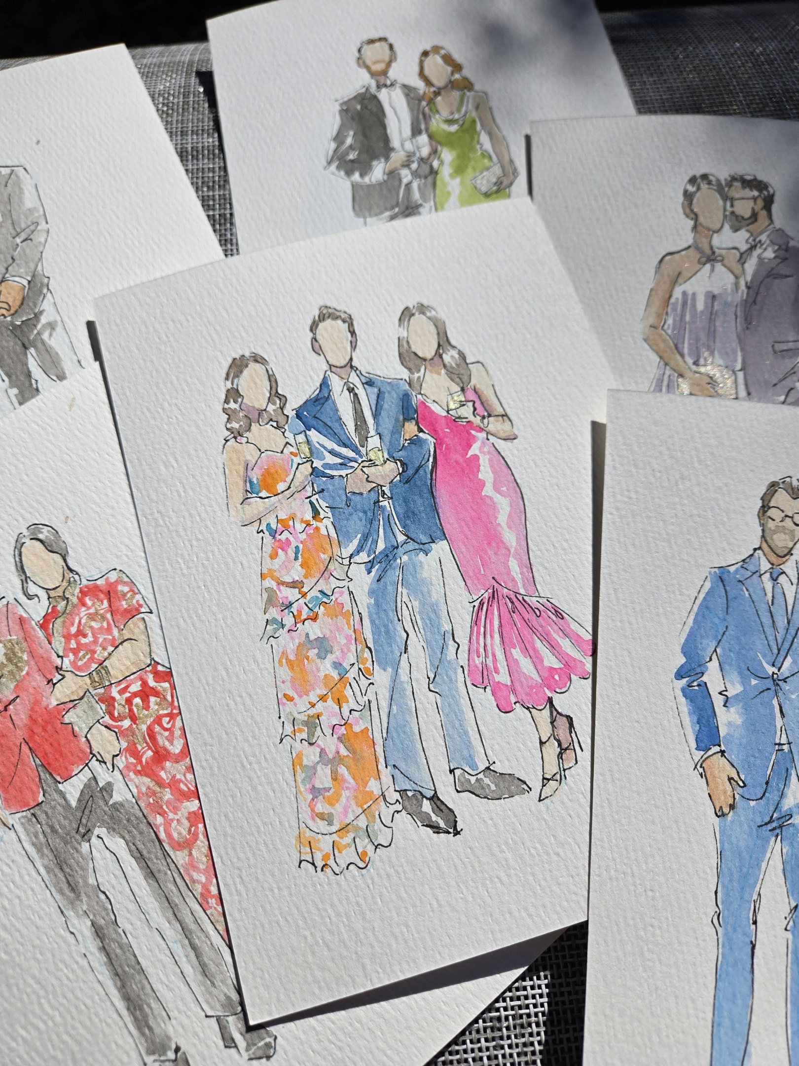 Wedding couple dancing while guests enjoy the reception during live portrait painting