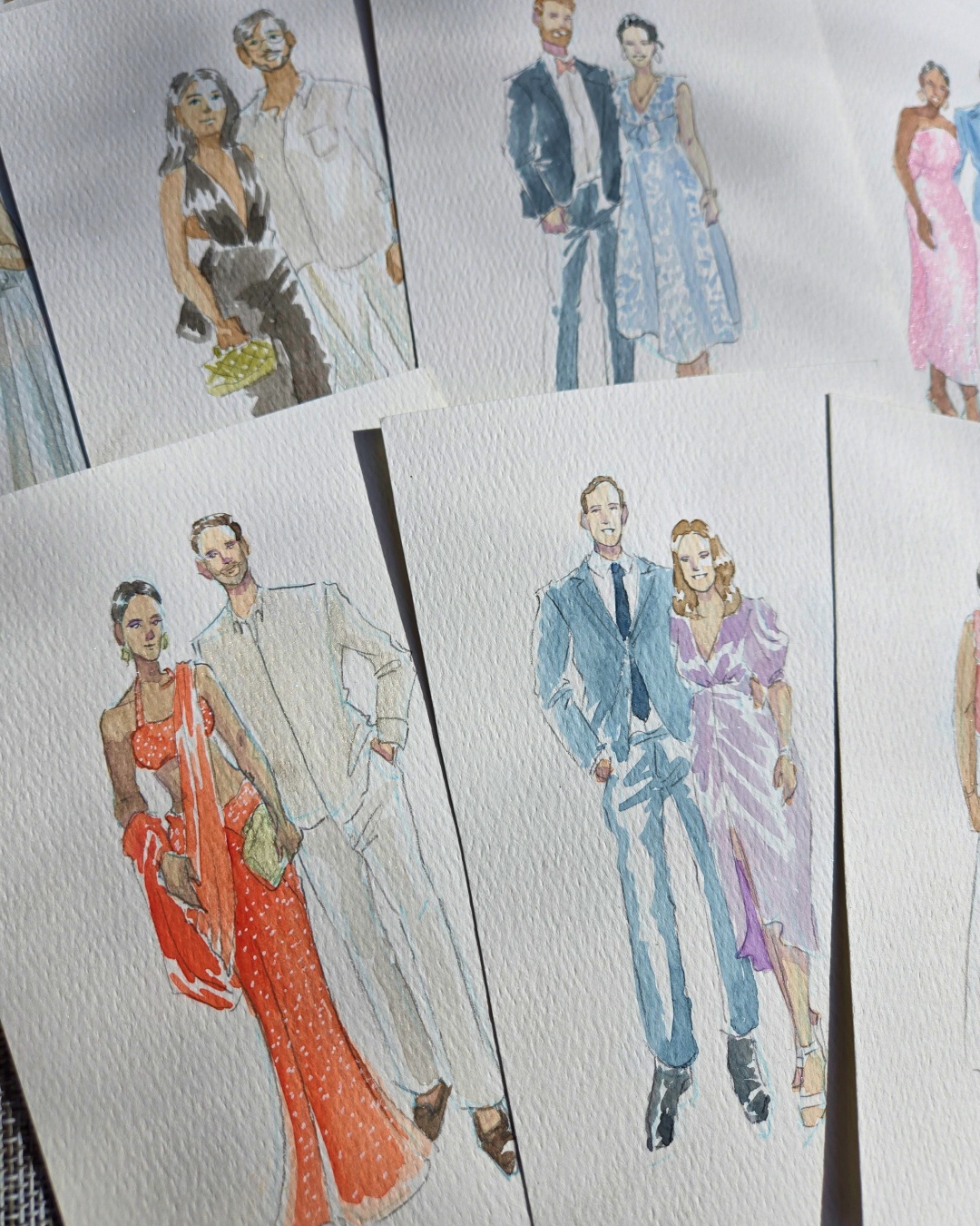 Two wedding guests posing for a reference photo before their live watercolour portraits are painted