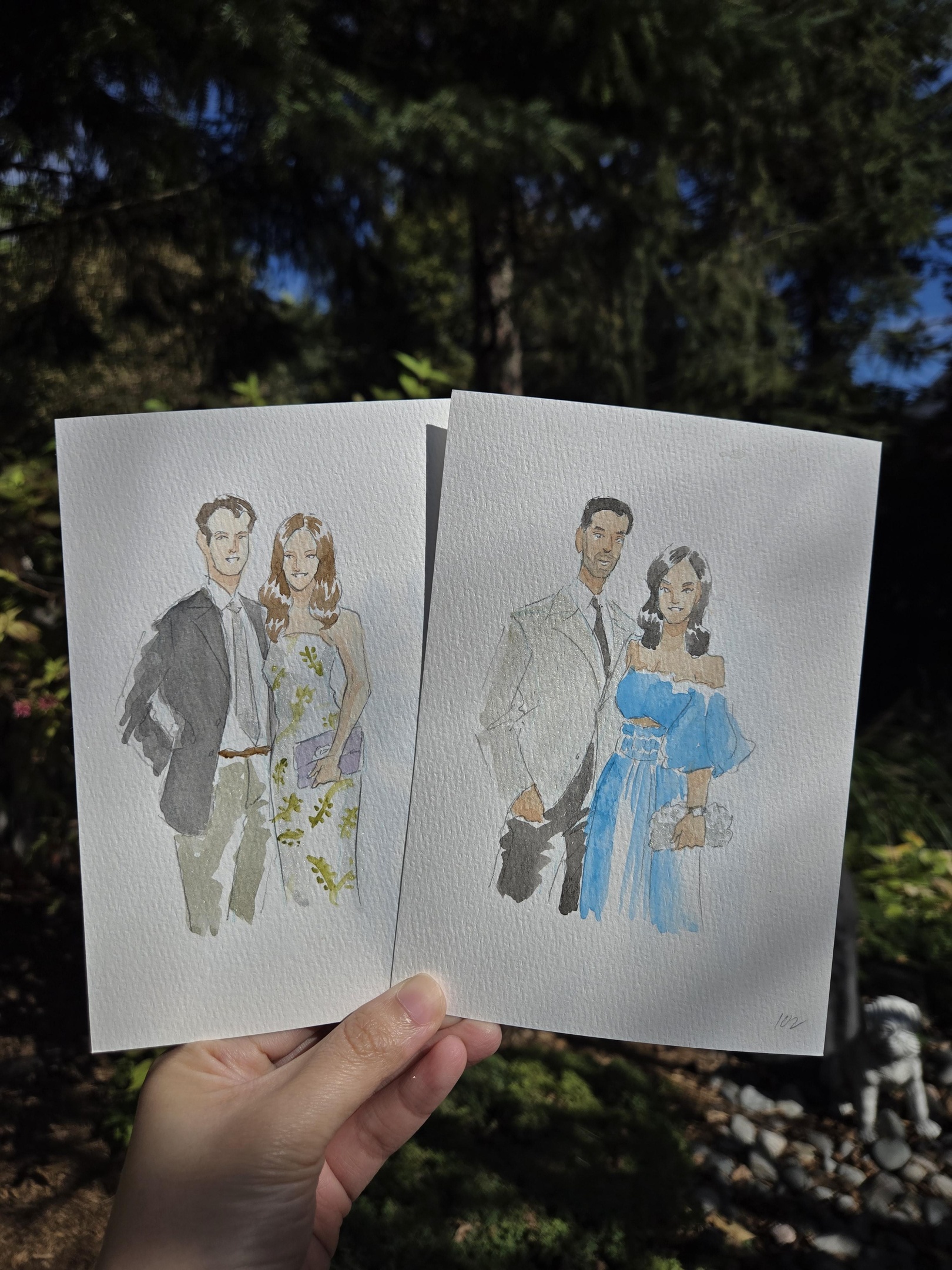 Close-up of a live artist painting a guest portrait in watercolour during a wedding